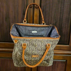 Calvin Klein travel bag or carry on bag on a plane.  Roomy with compartments.